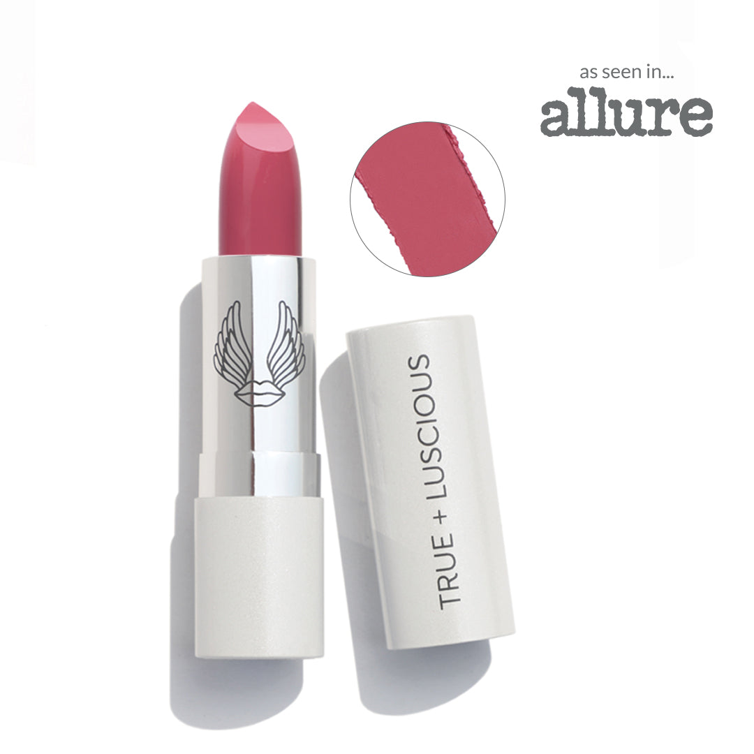 Lipstick with white casing and pink shade, featuring 'True + Luscious' brand name.