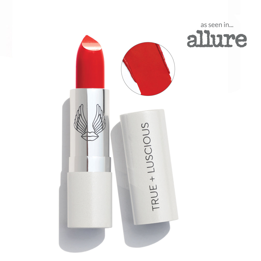 Red lipstick with white casing on a white background, featuring the 'True + Luscious' brand.