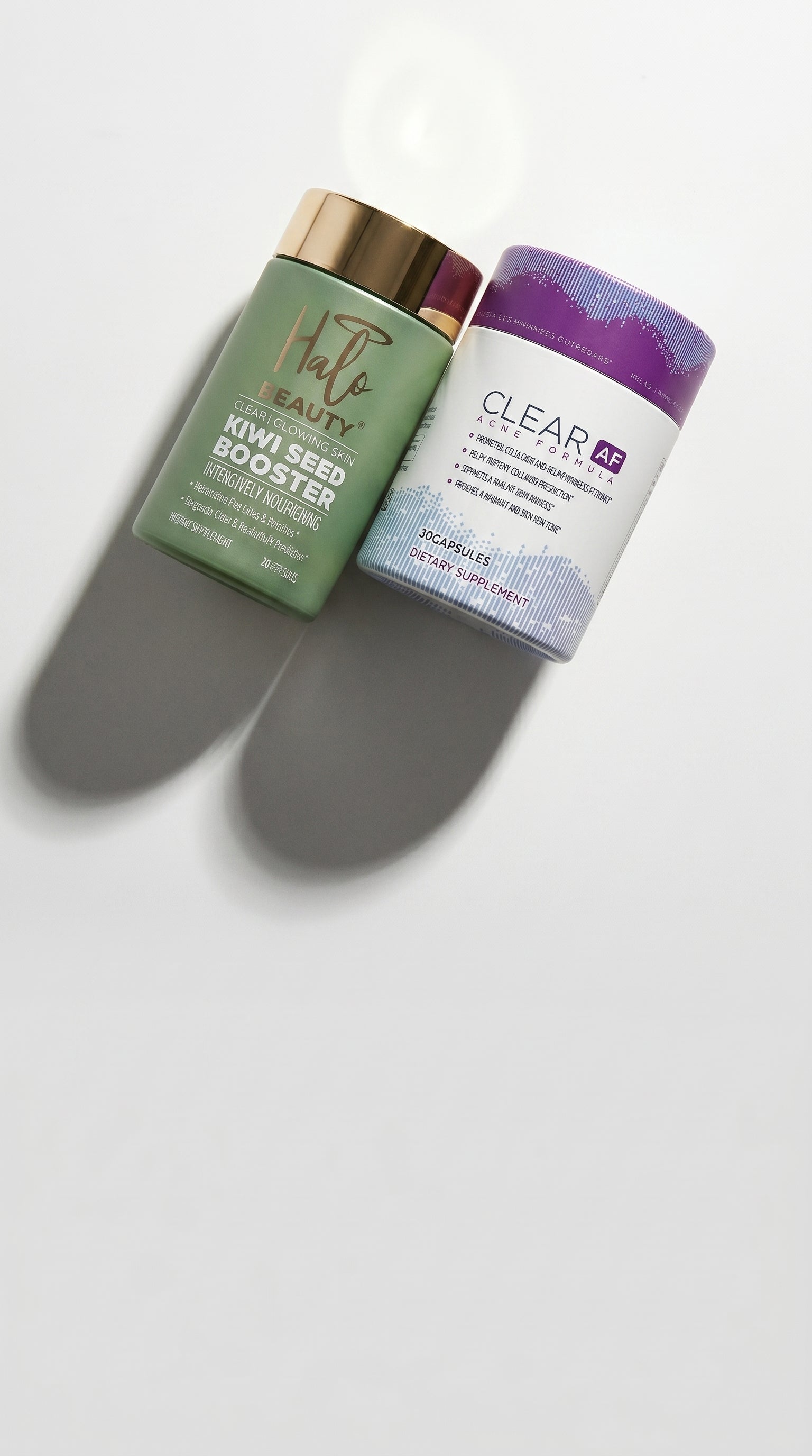 Two skincare products, 'Kiwi Seed Booster' and 'Clear', on a white background