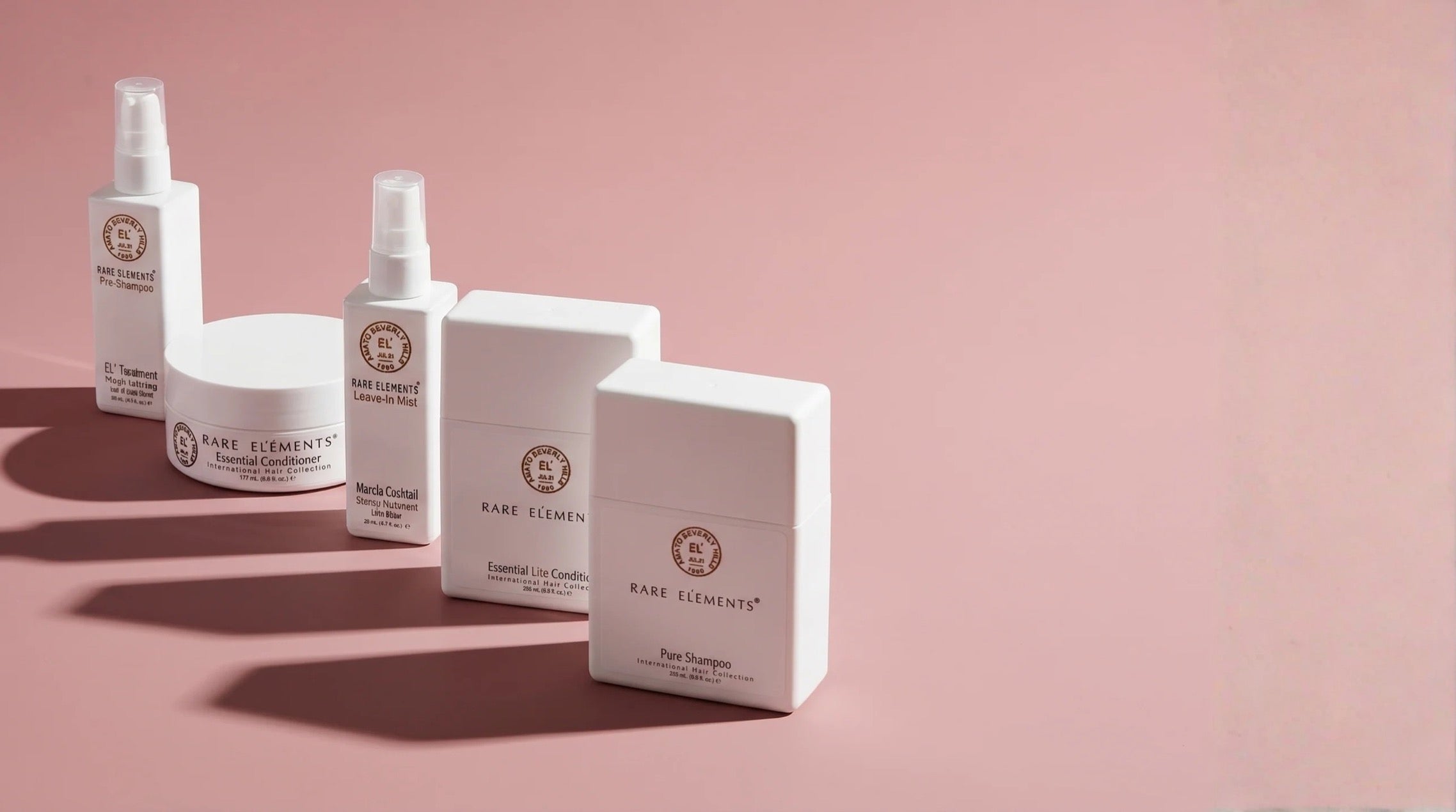 Rare Elements hair care collection on a pink background